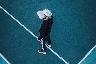 Man standing on tennis court with VR headset