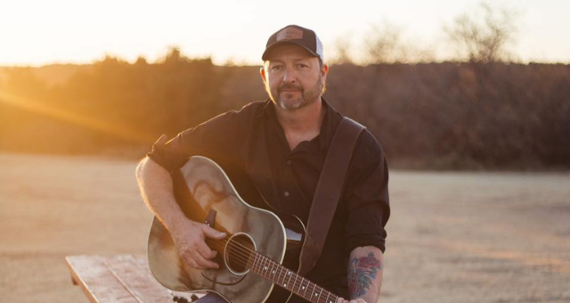 Brian Findley posing with guitar