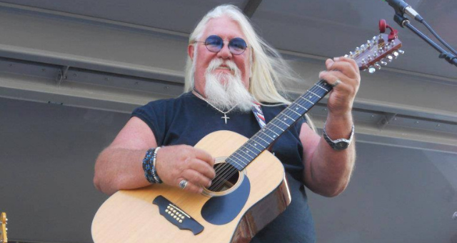 Mike Pritchard playing guitar